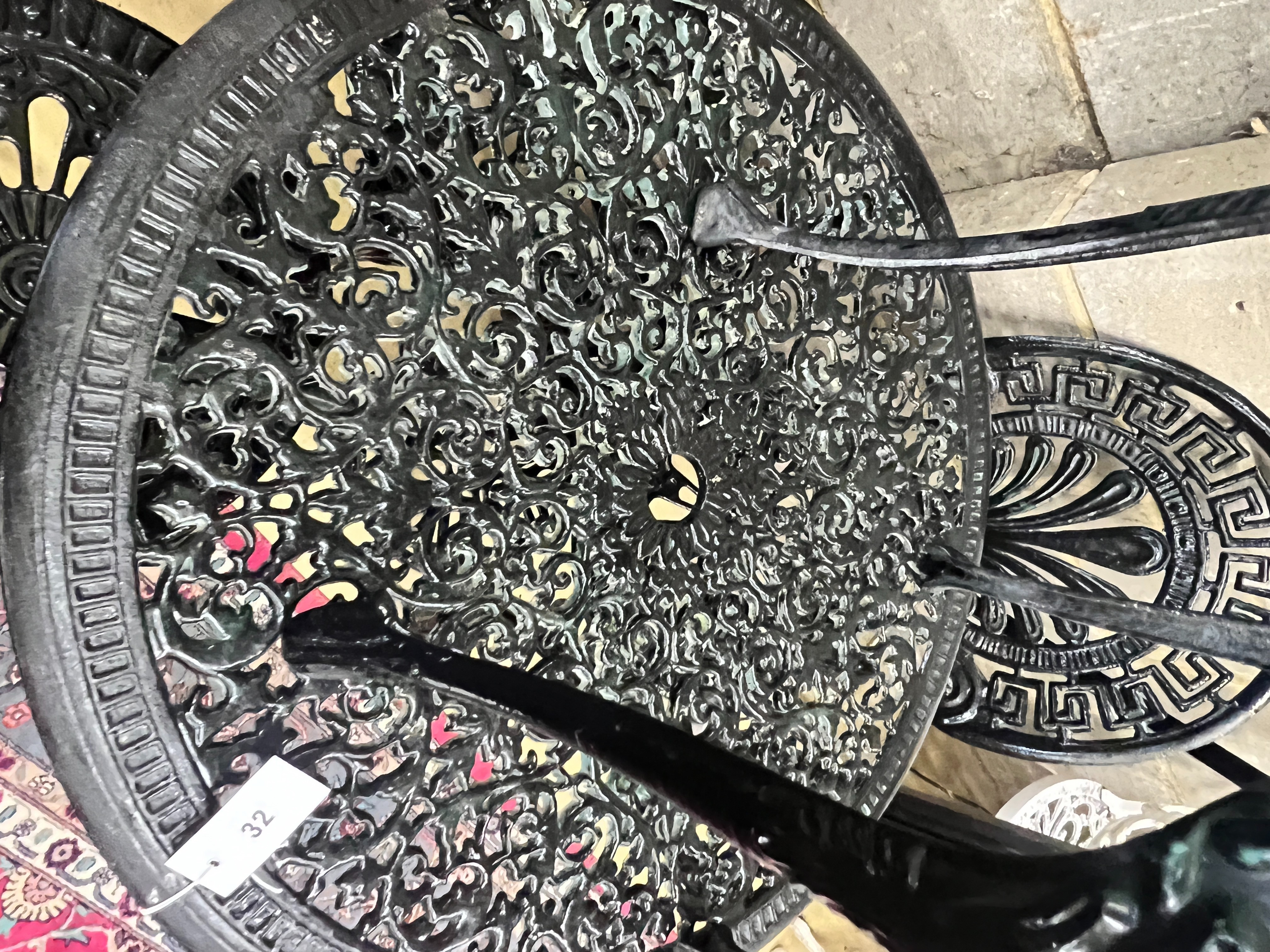 A Victorian style painted aluminium circular garden table, diameter 70cm, height 67cm and four chairs